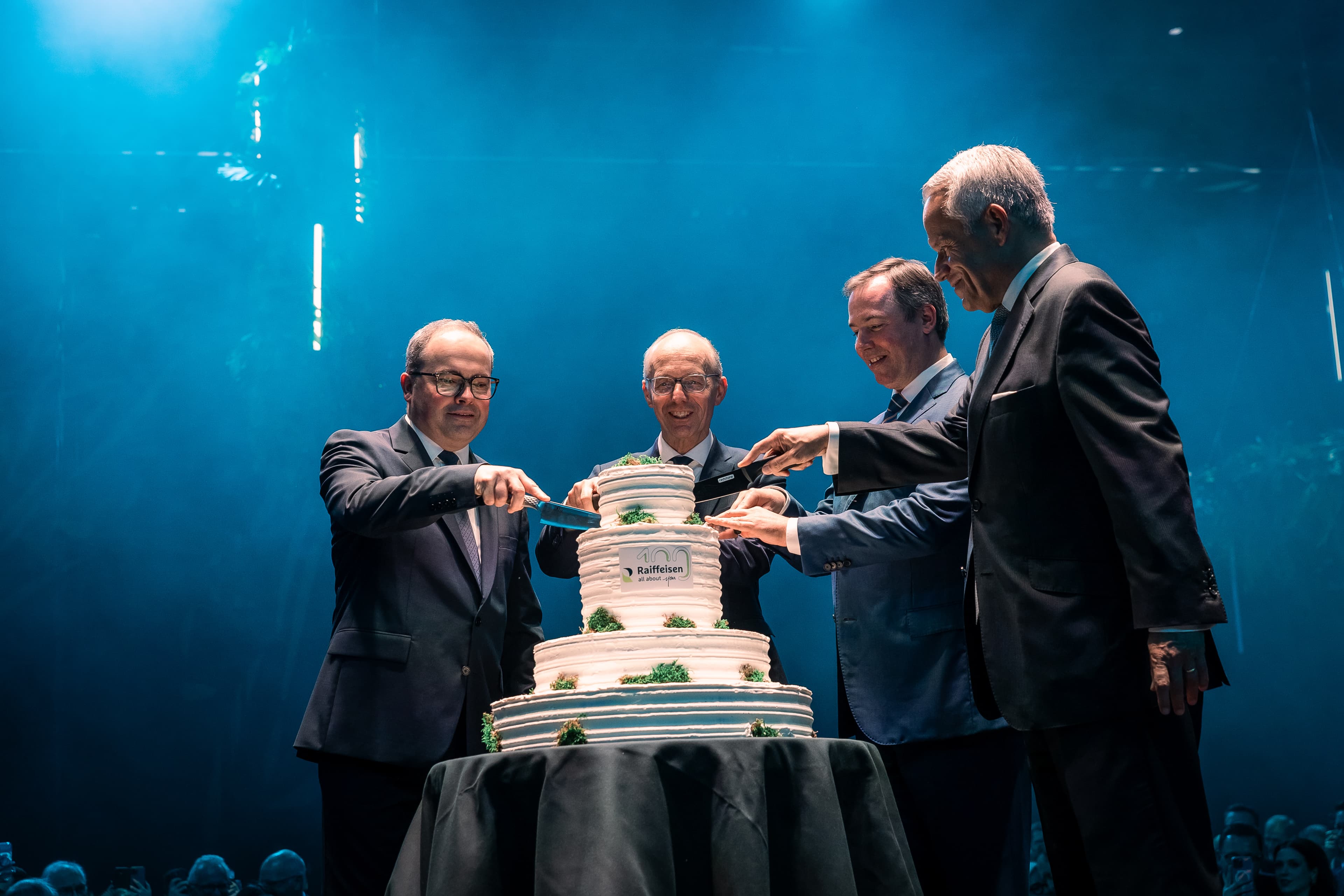 Cutting the stacked cake and celebrating 100th anniversary